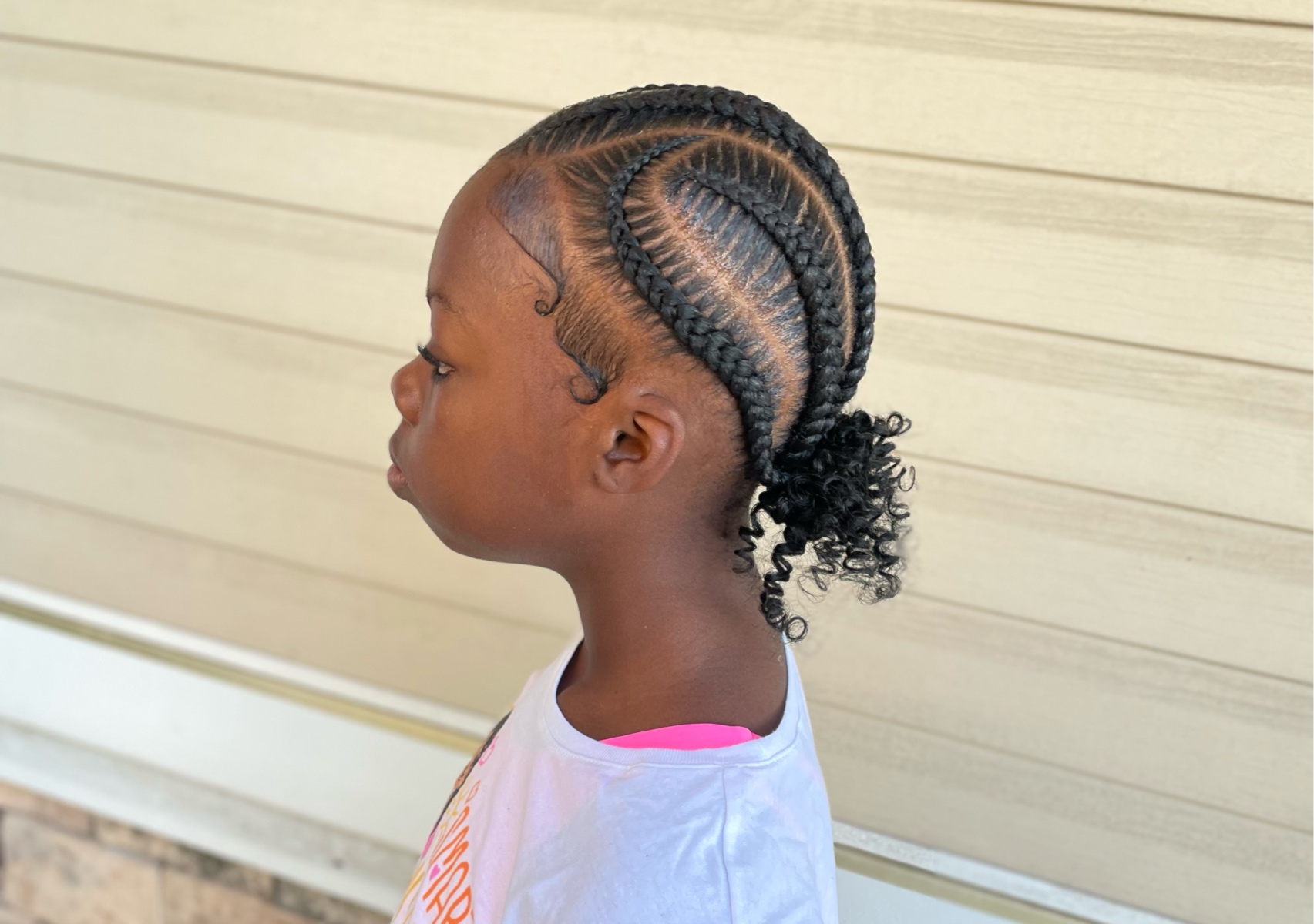 Little girl 6 freestyle stitch braids with curly bun 