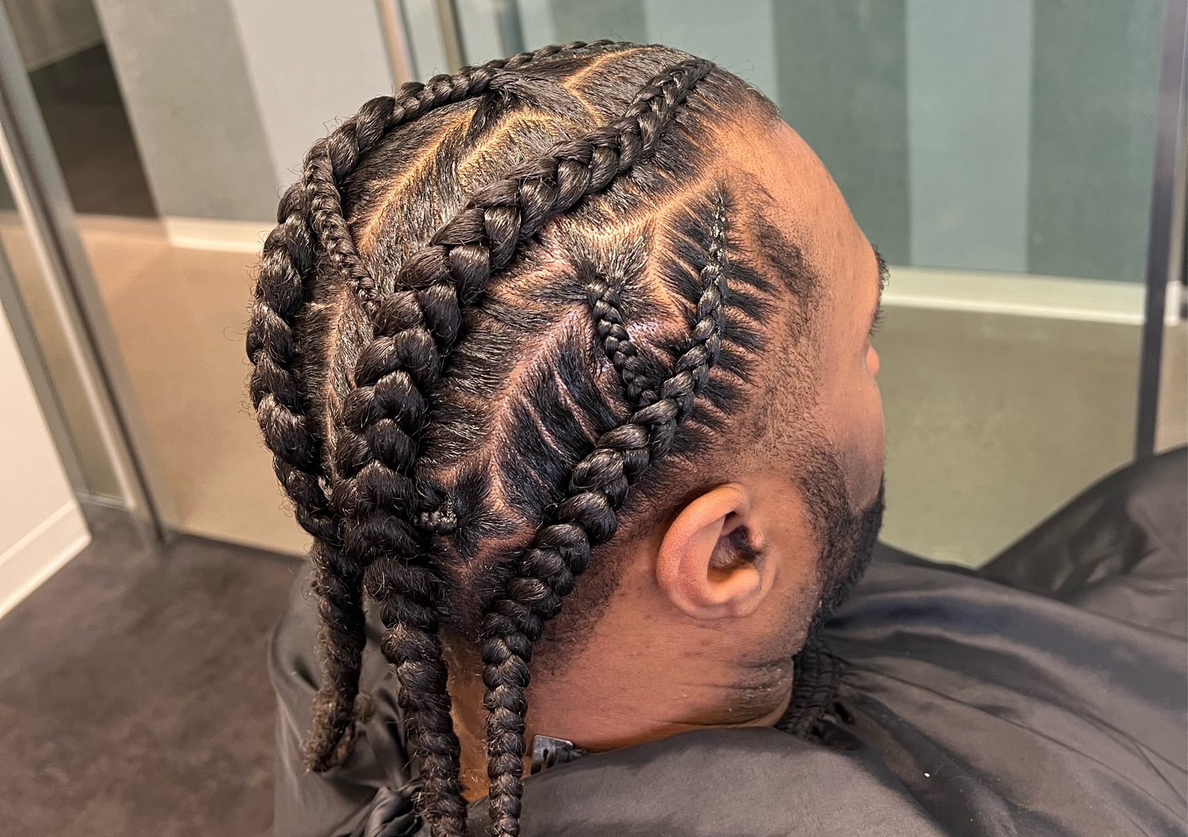 Men stitch braids  